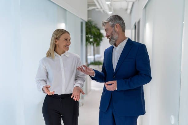 istock Two cheerful business partners having a conversation indoors 1480344946