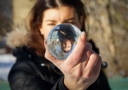 Close-up of a woman holding a crystal ball