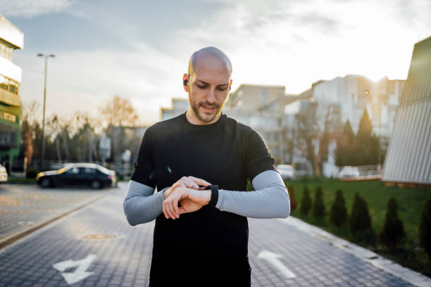 Young man using a fitness tracker stock photo