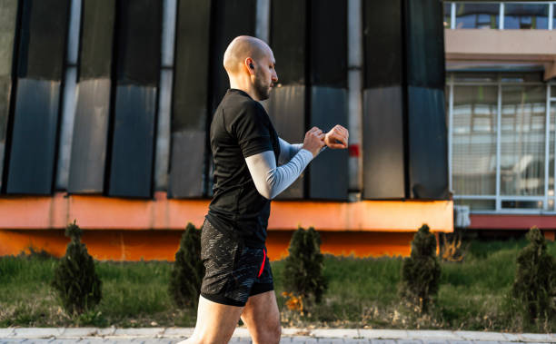 istock Man checks data on a fitness tracker while running 1480349303