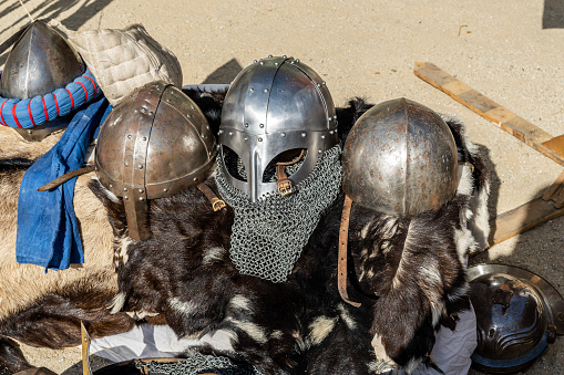 Costumed participants celebrate the Middle Ages in a recreation of a grand festival, wearing protective armour and helmets made from chain mail.