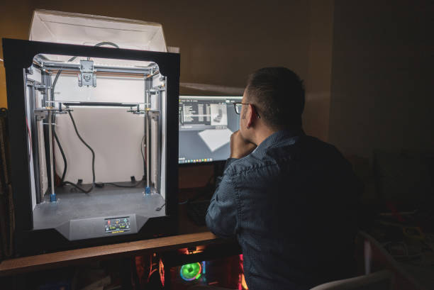 istock Mature engineer printing 3D model at night in house 1480351501
