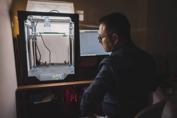 istock Mature engineer printing 3D model at night in house 1480353350