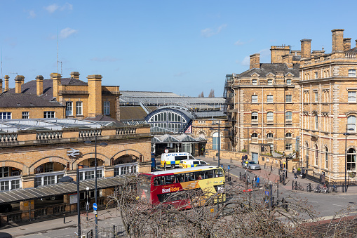 Exterior view of the architecture of the central main railway station at York in England UK. view shows station buildings, passengers and bus and travel connections