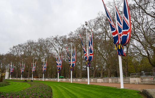 London, UK - April 6 2023: Union Jacks outside Buckingham Palace, which have been installed ahead of the coronation of King Charles III.