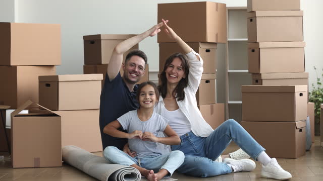 Happy family with daughter enjoying moving day to new house