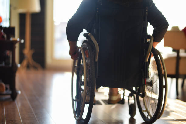 istock Wheelchair user on the move indoors 1480358621