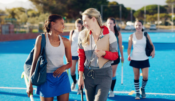 istock Team leader, hockey and happy discussion with player for coaching, teamwork or collaboration in the outdoors. Fitness sporting coach talking with athlete in friendly conversation for training tips 1480358641