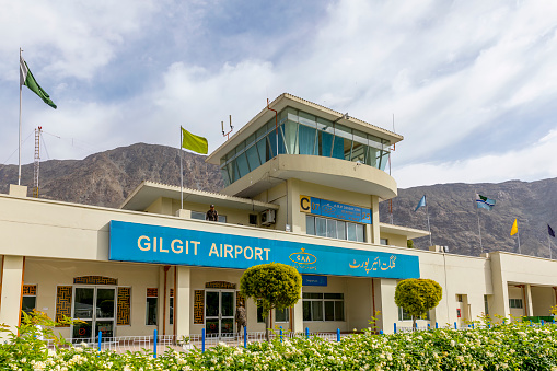 Gilgit, Pakistan - April 28, 2019: Standing tall amidst the breathtaking landscapes of Gilgit, the airport building with its air traffic control tower serves as a vital gateway connecting the world to the beauty of northern Pakistan.
