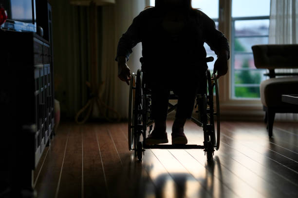 istock Wheelchair user on the move indoors 1480359484