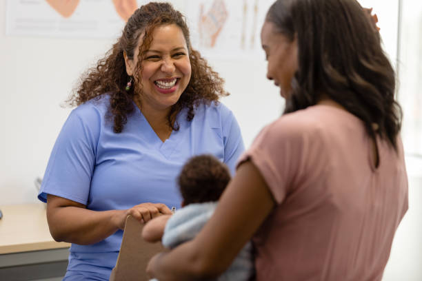 istock Female doctor with big smile talks to unrecognizable young mom 1480360653