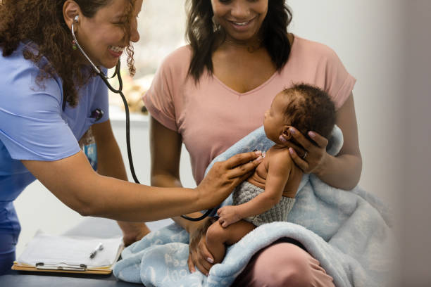 istock Smiling nurse uses stethoscope to check baby's heart and lungs 1480360659