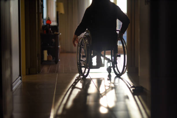Overcoming barriers: a woman in a wheelchair moving freely around her home