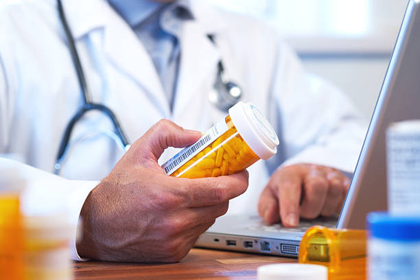 Doctor preparing online internet prescription stock photo