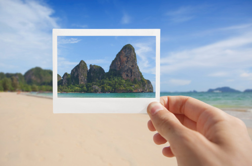 Hand With Photo of Beach.