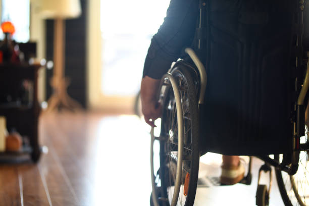 istock Wheelchair user on the move indoors 1480362883