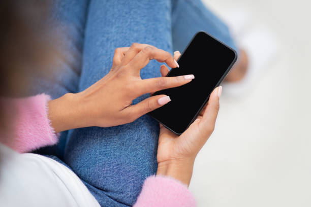Female hands holding cell phone with blank screen, mockup
