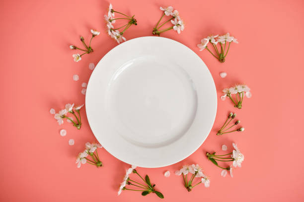 istock White flowers, cherry blossoms and Easter eggs with blue stripes on a pink background. Easter background, copy space. Flatlay. 1480363672