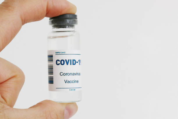 istock An ampoule with a vaccine in hand in close-up. 1480363988