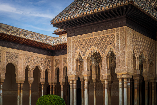 Detail of the Patio de Los Leones in the Alhambra, Granada, Spain, with plaster latticework and columns