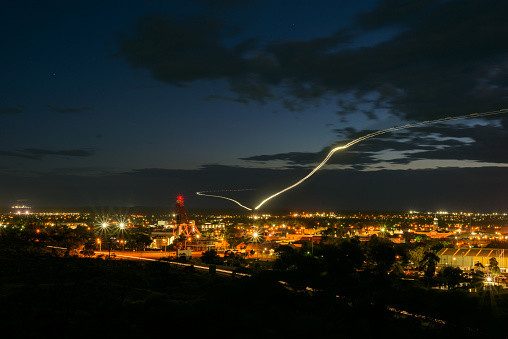 View of Kalgoorlie-Boulder in the twilight. With a light trail of an aircraft.  Western Australia, Australia