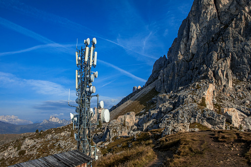 An outdoor remote telecom tower against a blue sky
