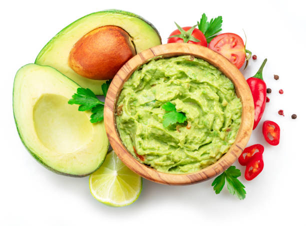 istock Guacamole bowl and guacamole ingredients isolated on white background. Flat lay. 1480377200