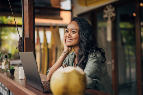istock Beautiful woman using laptop in bar 1480380894