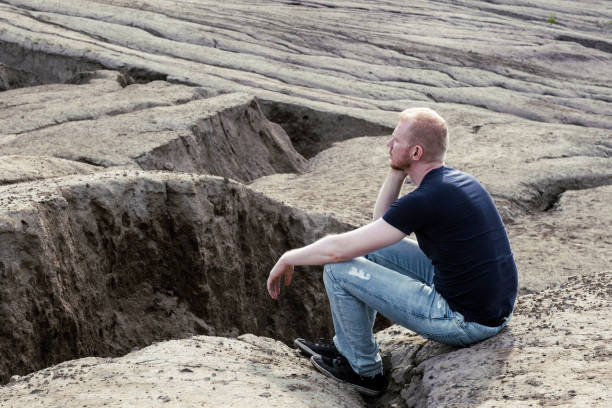 istock A man surrounded by mountains. Thoughtfulness and loneliness 1480380951