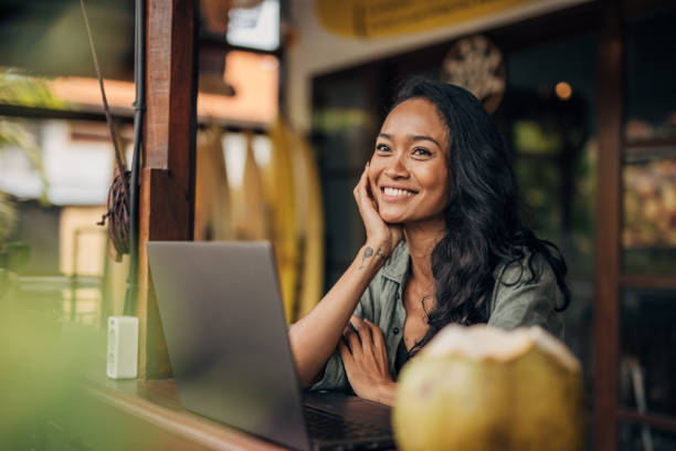 istock Beautiful woman using laptop in bar 1480380963