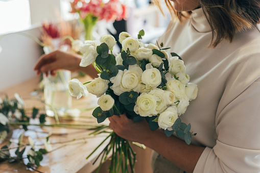 Woman florist is preparing a bouquet of flowers.Daily routine of running a small business