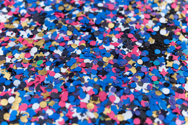 Close up view of Carnival confetti and paper ribbon on the ground.