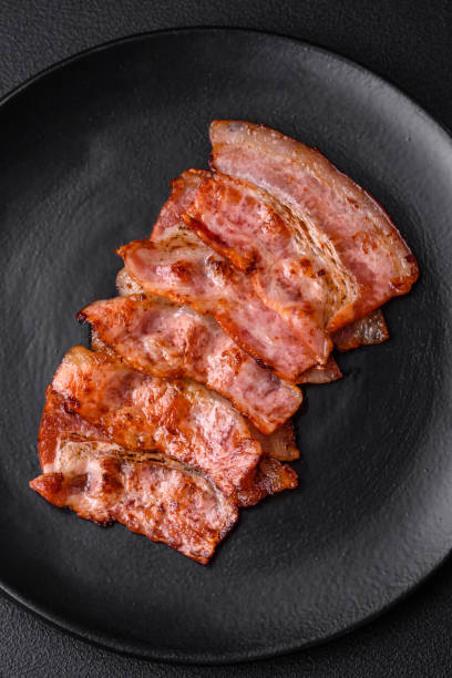 istock Delicious fresh fried bacon stripes with spices 1480383491