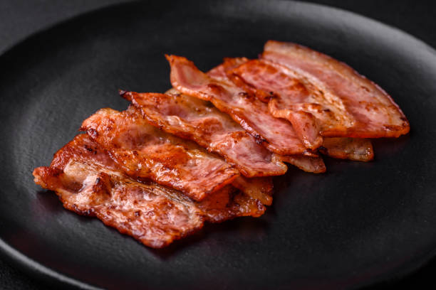 istock Delicious fresh fried bacon stripes with spices 1480383502