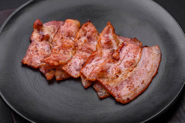 istock Delicious fresh fried bacon stripes with spices 1480383509