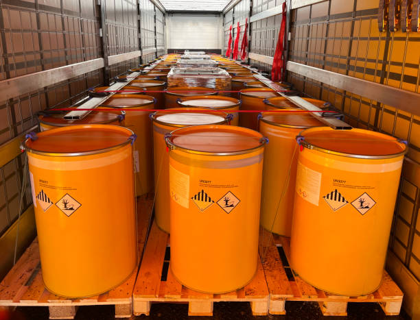 Loading, transportation and unloading of barrels with hazard class 9 in a semi-trailer. Transportation of dangerous goods by ADR cargo transport Loading, transportation and unloading of barrels with hazard class 9 in a semi-trailer. Transportation of dangerous goods by ADR cargo transport. hazardous material stock pictures, royalty-free photos & images