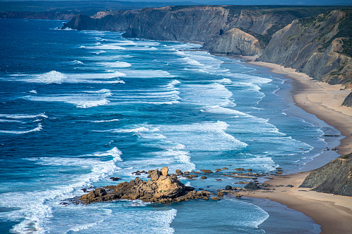 Crackington Haven bay in Cornwall, England, UK.  This is a popular little shale/pebble bay on the north Cornish coast protected by RNLI volunteers who run the lifeguard service on the beach.  The beach was gifted to the National Trust and is open to the public at no cost to use.