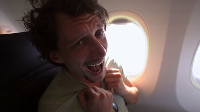 Male passenger having a panic attack on the plane