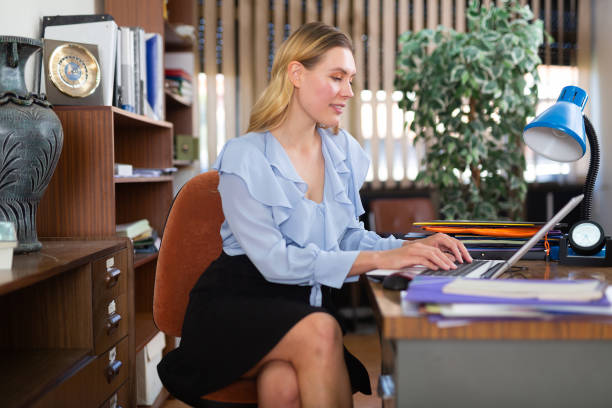 istock Successful businesswoman working with paperwork and laptop 1480404806