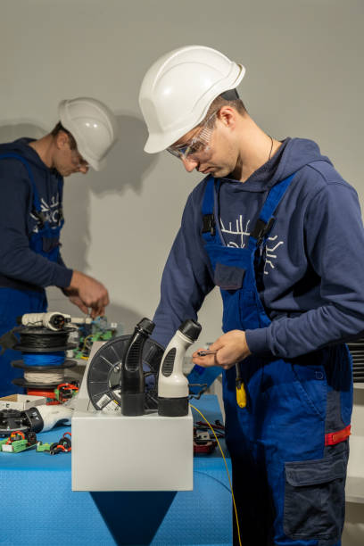 istock Foremen work with cables to install in plugs for charging EV 1480405122