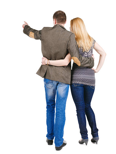 istock Back view of young couple pointing at wall. 148040586