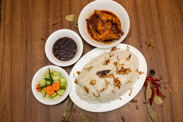 istock Plain rice with fried onion, chicken korma, gravy, sauce and salad with red chilli served in dish isolated on grey background top view food 1480415476