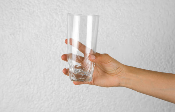 istock Hand with a glass cup on white background 1480418746