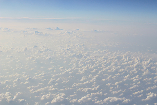 The View from the plane window above the cloud and blue sky