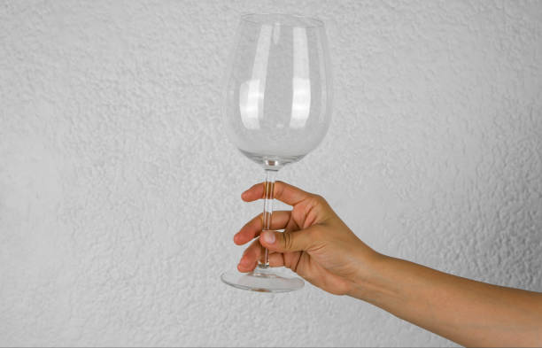 istock Hand with glass cup on white background 1480428110