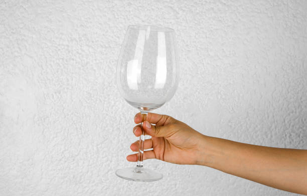 istock Hand with glass cup on white background 1480428112