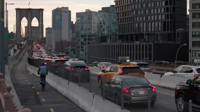 Evening traffic jam on the Brooklyn Bridge, with the view of modern Brooklyn's buildings.