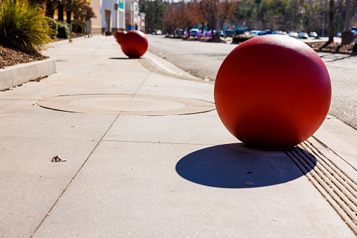 Parking barrier in the street in the shape of a sphere.