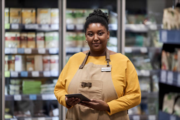 istock Black female worker in supermarket smiling at camera 1480439850