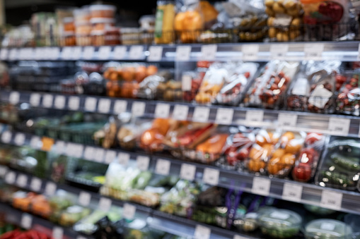 Background image of supermarket with shelves stacked with various fresh vegetables in freezer, copy space